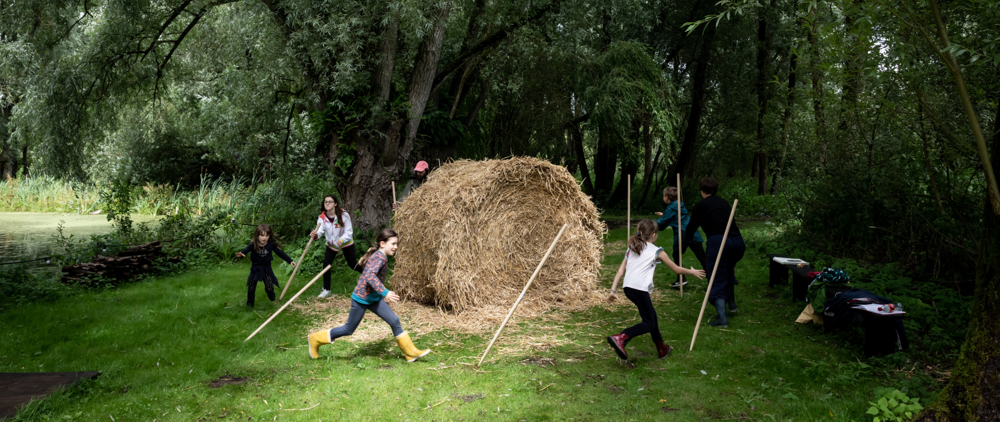 Childrens playing with hay stacks